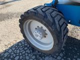 a tractor that is parked on the side of the road