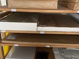 a shelf with a lot of boxes and papers on it