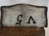 a wooden chair with a number painted on it