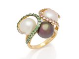 a close up of a ring with pearls and diamonds