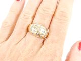 a woman ' s hand with a gold ring on it