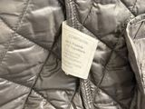 a label on the back of a quilted jacket