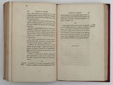 a open book on a white table with a red border