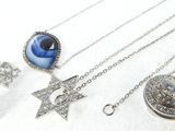 many different types of necklaces and earrings on a white surface