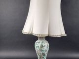 a white lamp with a white shade on top of it