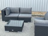 a couch, chair, coffee table and coffee table outside
