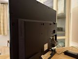 a flat screen tv sitting on top of a kitchen counter