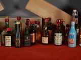 many bottles of alcohol lined up on a red table