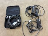 a black case with wires and a charger on the floor