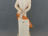 a figurine of a man sitting on top of a box
