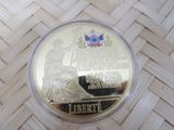a picture of a commemorative coin with a statue on it