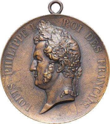an image of a bronze medal with a man ' s head on it