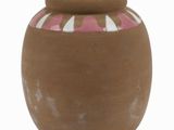 a brown vase with a pink and white design on it