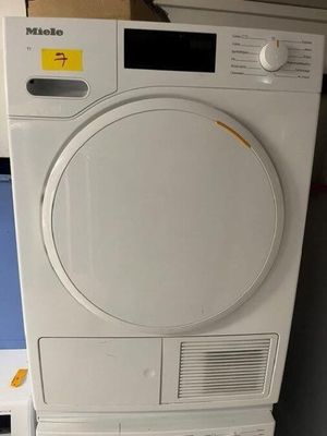 a dryer that is sitting on top of a stack of boxes