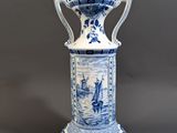 blue and white vase with a ship scene on it
