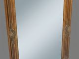 an image of a gold framed mirror against a gray background