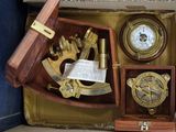 a box with a clock, compass, and other items in it