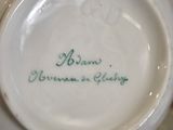 a close up of a tea pot with a name on it