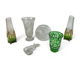 several pieces of glass sitting on top of a table next to each other