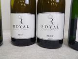 three bottles of wine are lined up on a table