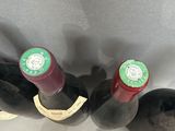 three bottles of wine sitting in a wine cooler