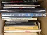 many books stacked on top of each other in a box