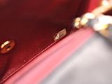 a close up of a red purse with a gold handle