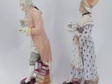 pair of porcelain figurines of a man and a woman