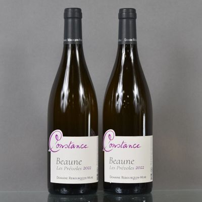 two bottles of wine sitting on top of a table next to each other