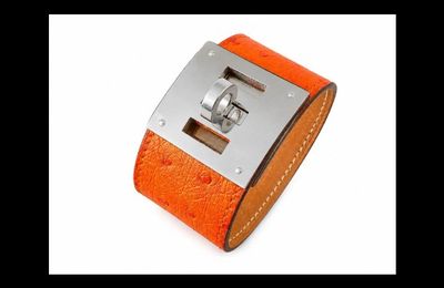 an orange leather cuff with a metal buckle on it