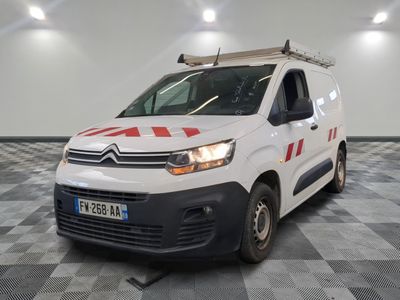 the white van is parked in a large room with a checkered floor