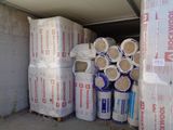 many rolls of insulation sitting in a storage area