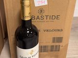 a bottle of wine sitting next to a box of wine