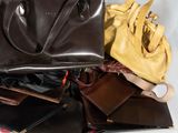 many bags and purses that are sitting on a table