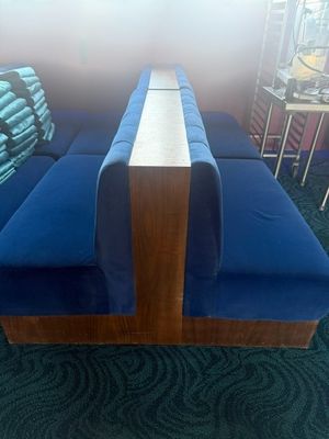 un canapé bleu posé sur un sol recouvert de moquette