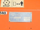 a close up of a sign on an orange machine