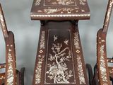 three pieces of furniture that are sitting on a table and chairs