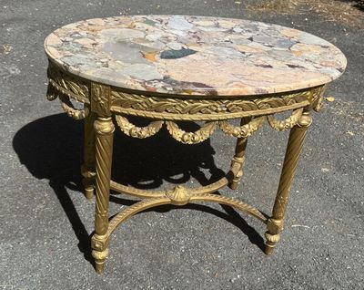 a small table with a marble top on the street