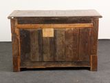 a small wooden chest with a door on top of it