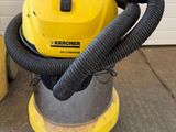 a close up of a yellow and black vacuum cleaner on a concrete floor