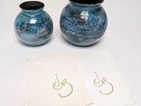 two blue vases sitting next to each other on a table