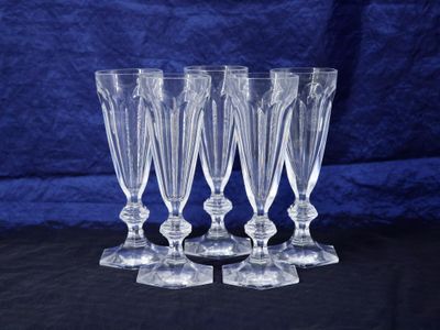 a set of four clear glass wine glasses sitting on top of a table
