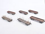 a lot of toy train cars that are sitting on a table