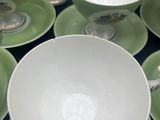 a lot of cups and saucers on the table
