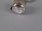 silver plated salt and pepper shaker on a white surface