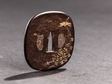 a small brown piece of metal on a table