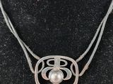 a close up of a necklace on a mannequin mannequin