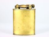 a small brass lighter that is sitting on a white surface