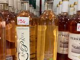 bottles of wine are lined up on a shelf in a store