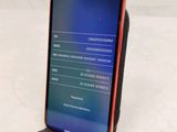 an image of a red and black phone sitting on top of a table